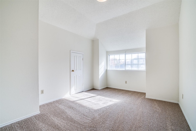 carpeted empty room with a textured ceiling