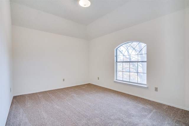 carpeted spare room featuring a textured ceiling