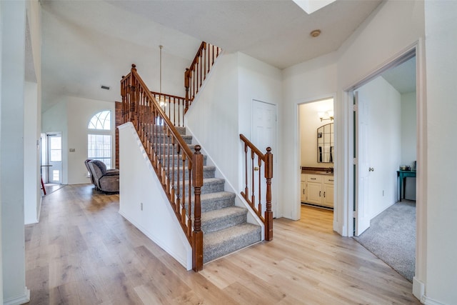 stairs with hardwood / wood-style floors