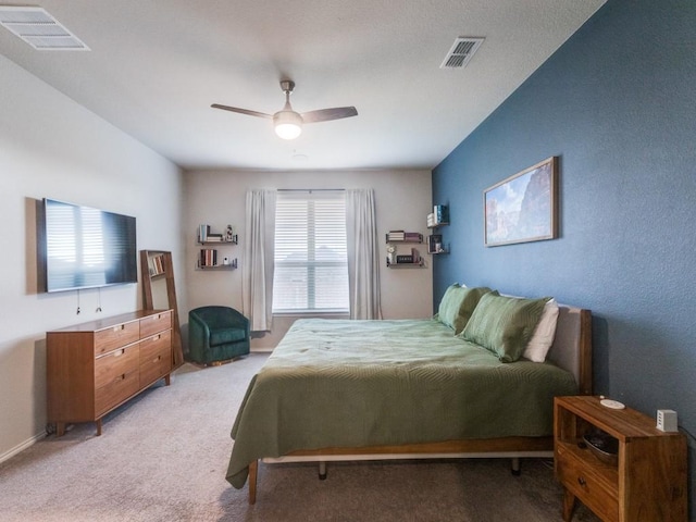 bedroom featuring ceiling fan and light carpet