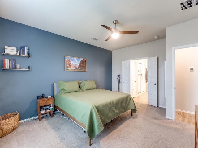 bedroom with light carpet and ceiling fan