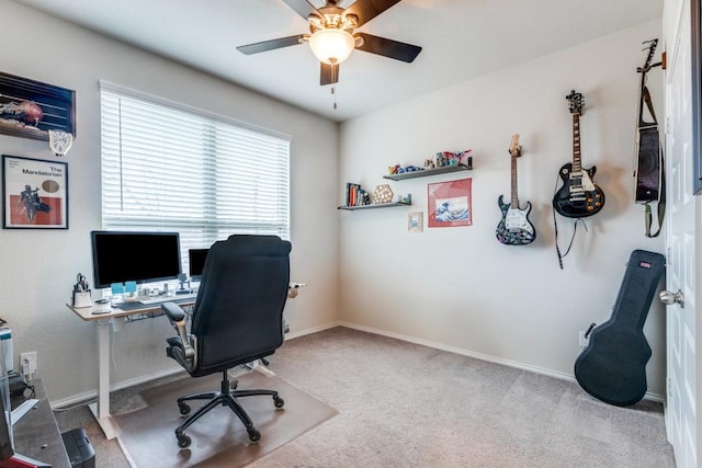 carpeted office featuring ceiling fan