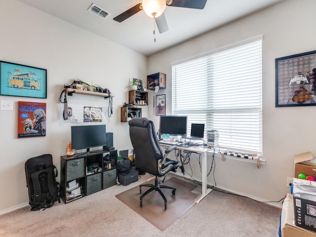 office featuring ceiling fan, light colored carpet, and plenty of natural light