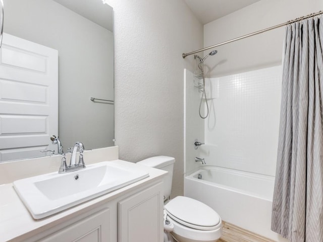 full bathroom with shower / bathtub combination with curtain, vanity, and toilet