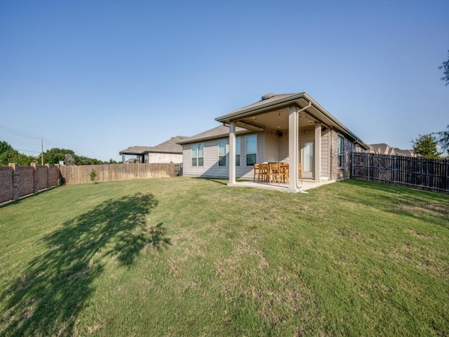 back of property featuring a lawn and a patio area