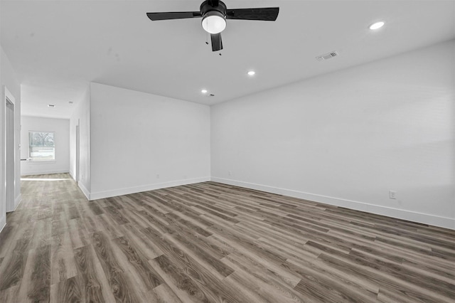 unfurnished room with ceiling fan and wood-type flooring