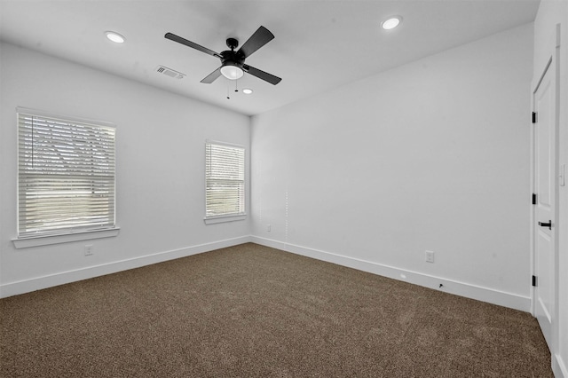 spare room featuring ceiling fan and carpet floors