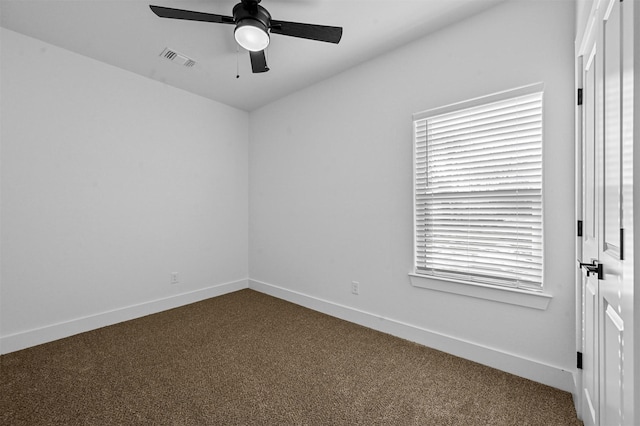 empty room featuring carpet flooring, ceiling fan, and a healthy amount of sunlight