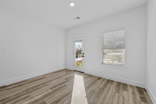 spare room featuring light hardwood / wood-style flooring