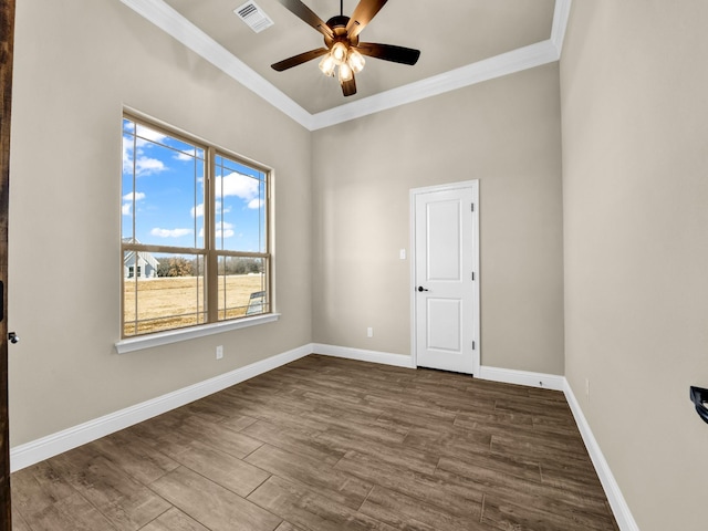 empty room with ceiling fan, crown molding, and dark hardwood / wood-style flooring