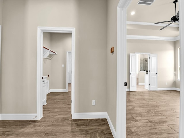 hallway featuring ornamental molding