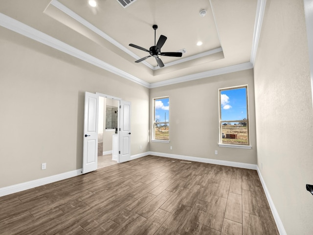 spare room with a raised ceiling, ceiling fan, and crown molding