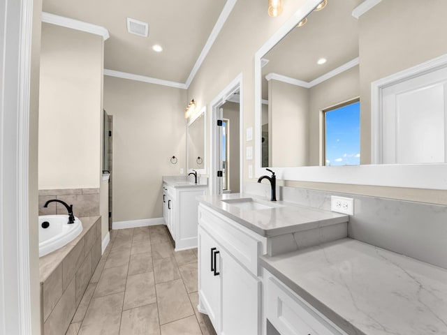 bathroom featuring tiled bath, tile patterned flooring, crown molding, and vanity