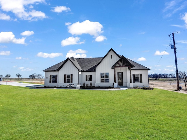 modern farmhouse style home with a front yard