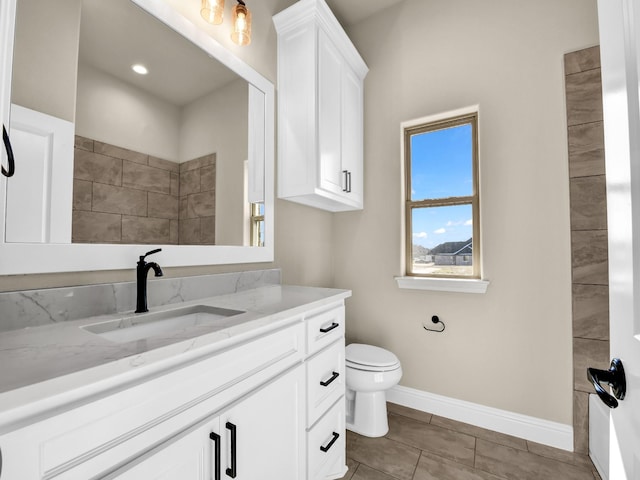 bathroom with vanity, tile patterned floors, and toilet