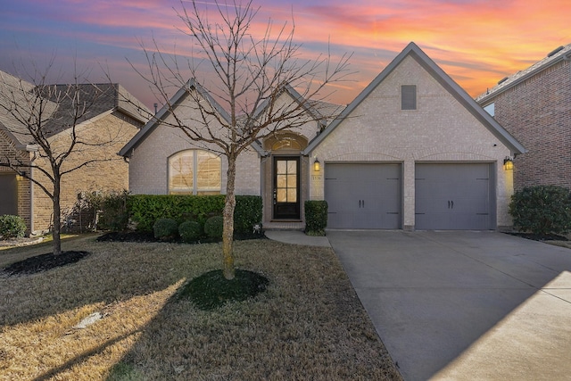 view of property featuring a lawn and a garage