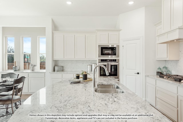 kitchen with sink, stainless steel appliances, and white cabinets