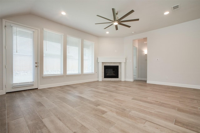 unfurnished living room featuring light hardwood / wood-style floors, ceiling fan, and plenty of natural light