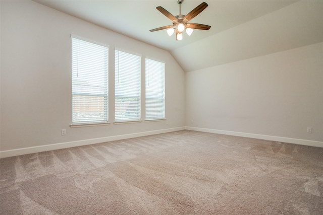 additional living space featuring ceiling fan, lofted ceiling, and carpet flooring