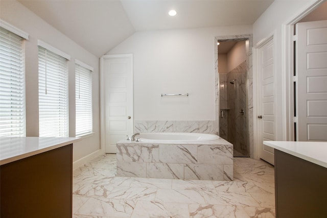 bathroom featuring separate shower and tub, lofted ceiling, and vanity