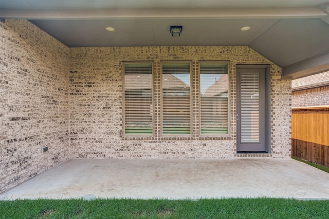 view of exterior entry featuring a patio