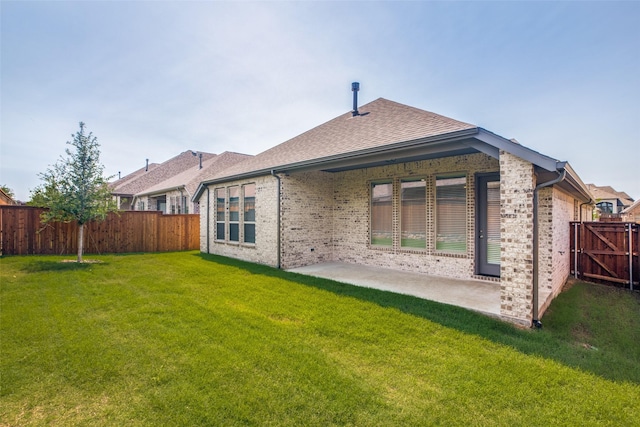 back of property featuring a patio area and a lawn