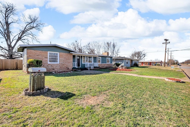 ranch-style home featuring a porch and a front lawn