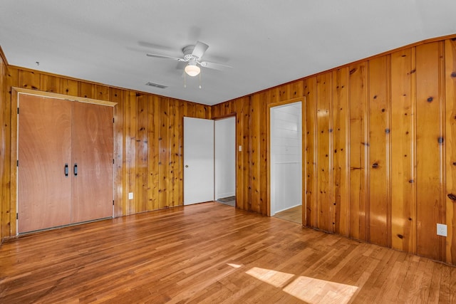 unfurnished bedroom with ceiling fan and light hardwood / wood-style floors