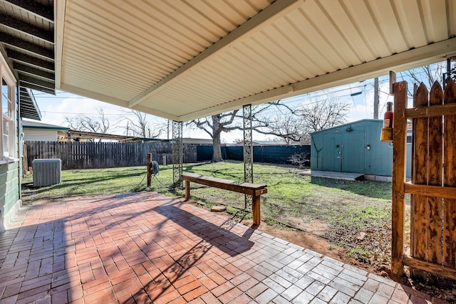 view of patio / terrace with central AC and a storage shed