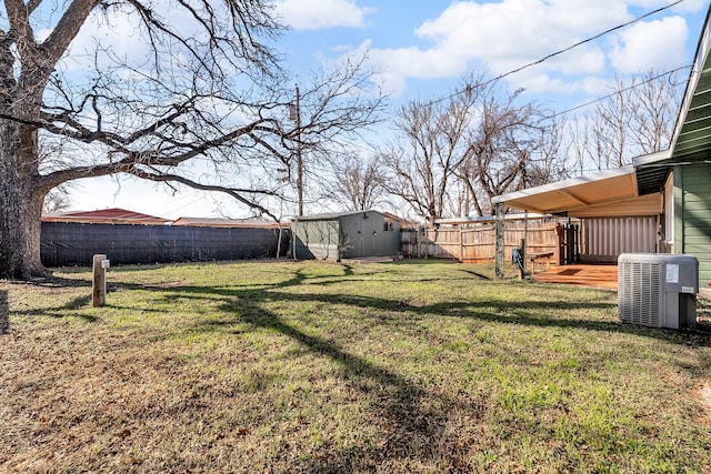 view of yard featuring central air condition unit and a shed