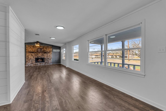 unfurnished living room featuring ceiling fan, dark wood-type flooring, lofted ceiling, and a fireplace