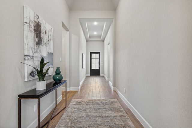 corridor with hardwood / wood-style floors