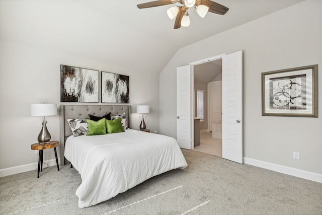 carpeted bedroom with ceiling fan and vaulted ceiling