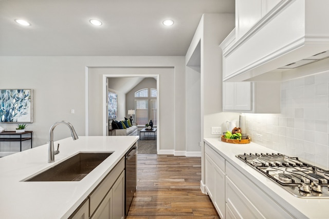 kitchen featuring sink, white cabinetry, premium range hood, dark hardwood / wood-style floors, and appliances with stainless steel finishes