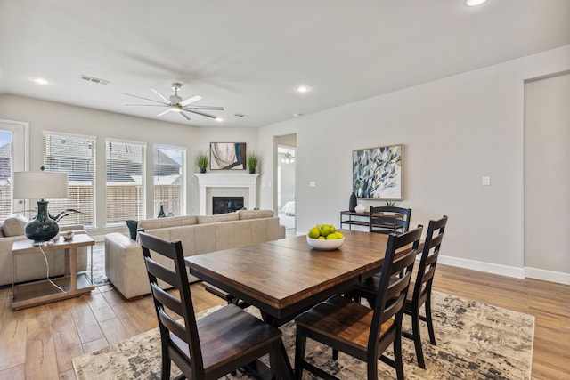 dining room featuring ceiling fan and light hardwood / wood-style flooring