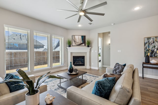 living room featuring ceiling fan and hardwood / wood-style floors