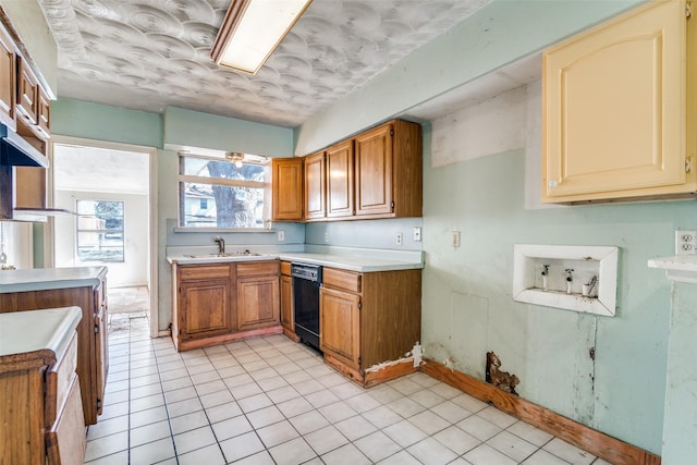 kitchen with sink, light tile patterned floors, and black dishwasher