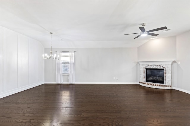 unfurnished living room featuring ceiling fan with notable chandelier, dark hardwood / wood-style flooring, and vaulted ceiling