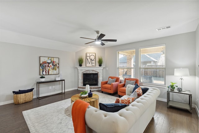 living room featuring lofted ceiling, a brick fireplace, ceiling fan, and dark hardwood / wood-style floors