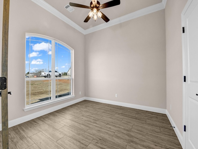 unfurnished room featuring ceiling fan and ornamental molding