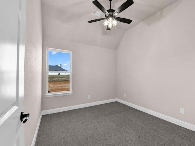 carpeted empty room with ceiling fan and vaulted ceiling