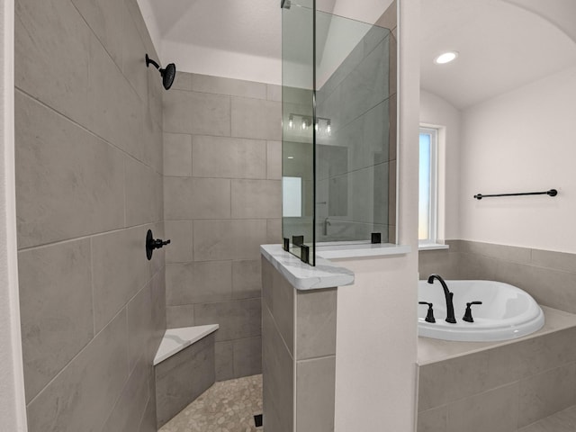 bathroom featuring shower with separate bathtub