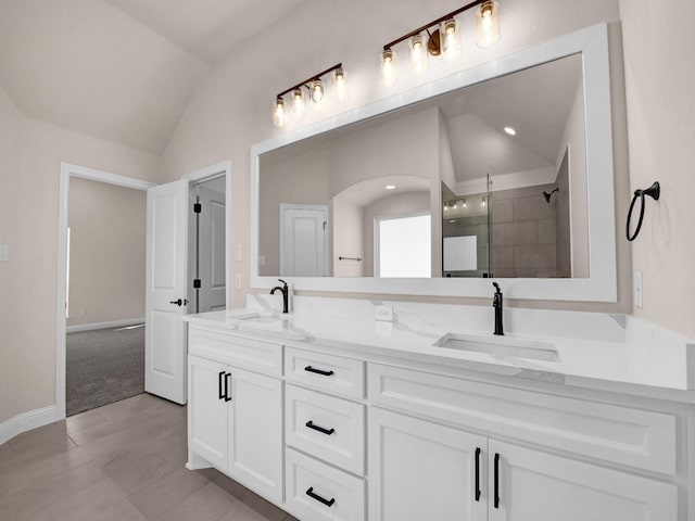 bathroom with lofted ceiling, a shower with shower door, and vanity