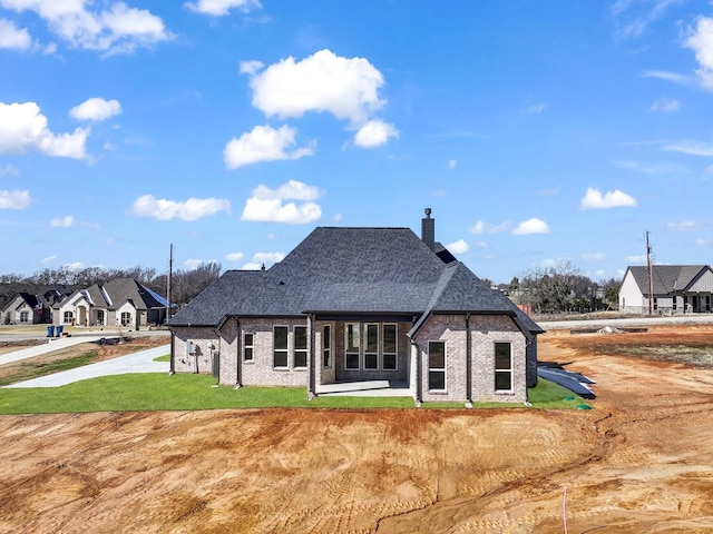 rear view of house with a lawn