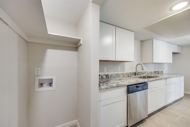 kitchen with stainless steel dishwasher, white cabinets, and sink