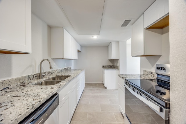 kitchen featuring appliances with stainless steel finishes, white cabinetry, light stone counters, and sink