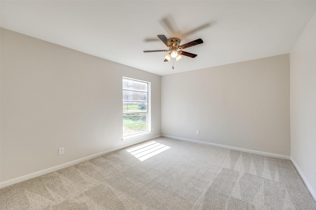 spare room with light colored carpet and ceiling fan