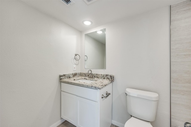 bathroom with toilet and vanity