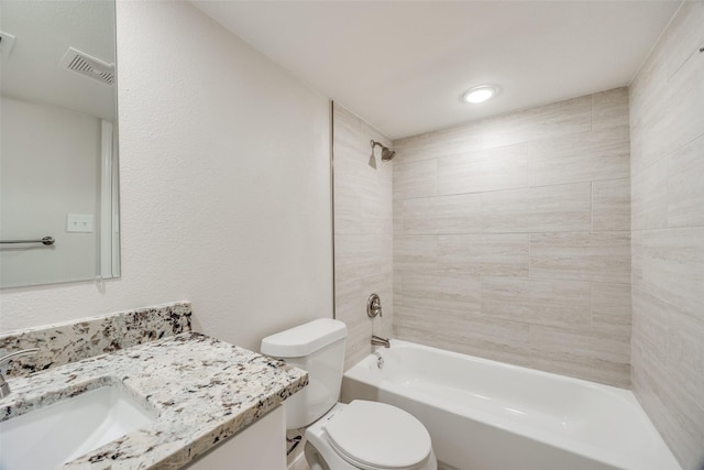 full bathroom featuring toilet, vanity, and tiled shower / bath combo