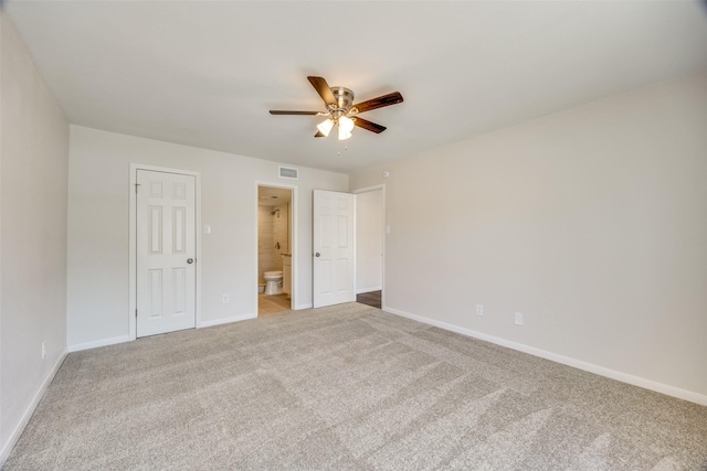 unfurnished bedroom with ceiling fan, connected bathroom, a closet, and carpet flooring